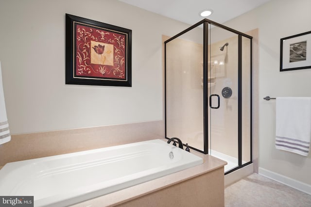 bathroom featuring shower with separate bathtub