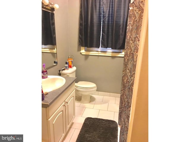 bathroom featuring tile floors, toilet, and vanity