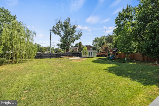 view of yard with a playground and a storage shed