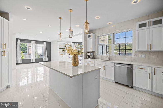 kitchen with stainless steel dishwasher, white cabinetry, and a healthy amount of sunlight