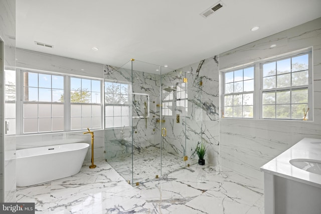 bathroom with vanity, tile walls, and shower with separate bathtub