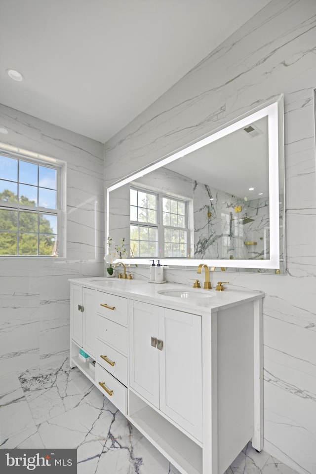 bathroom with vanity and a wealth of natural light