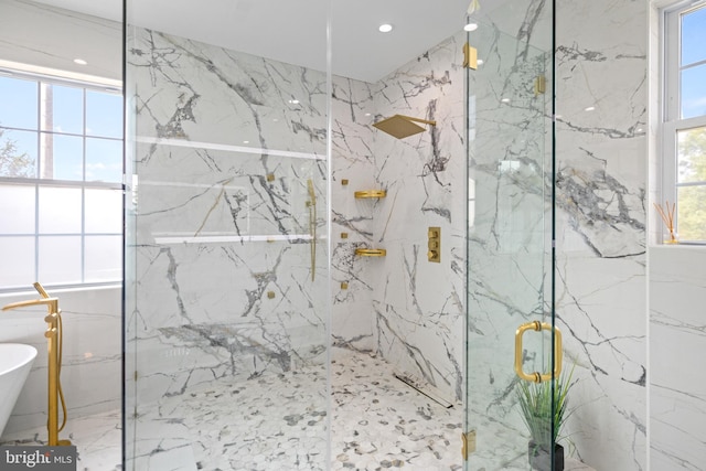 bathroom featuring shower with separate bathtub and a wealth of natural light