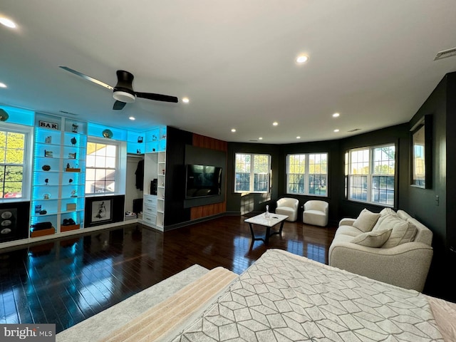 living room with dark wood-type flooring and ceiling fan