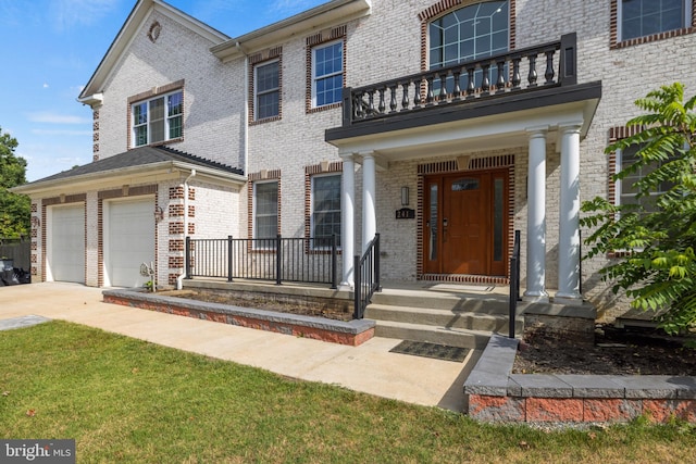 view of front of house with a balcony, covered porch, a garage, and a front lawn