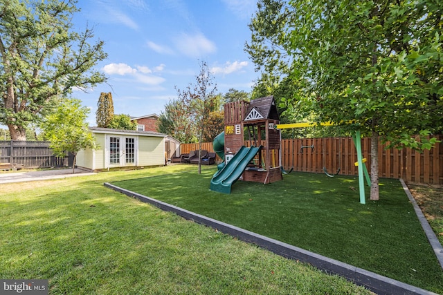 view of playground with a lawn and an outdoor structure