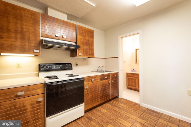 kitchen featuring tile floors, sink, and white electric range oven