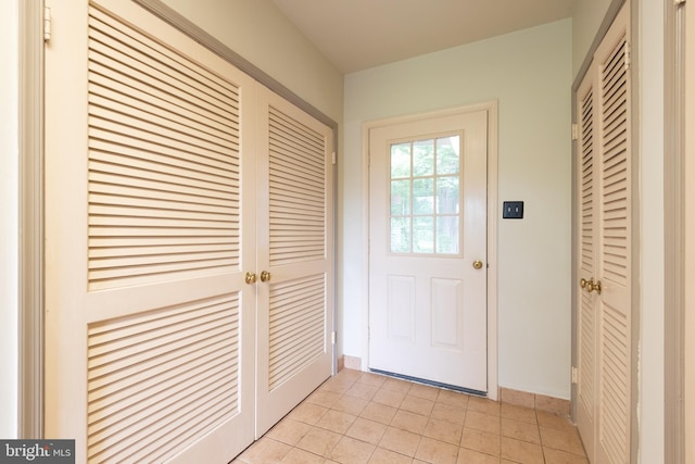 doorway to outside featuring light tile floors