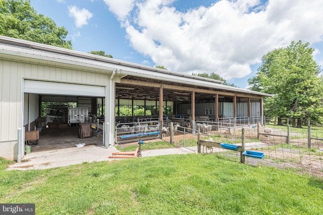 exterior space with an outdoor structure and a yard