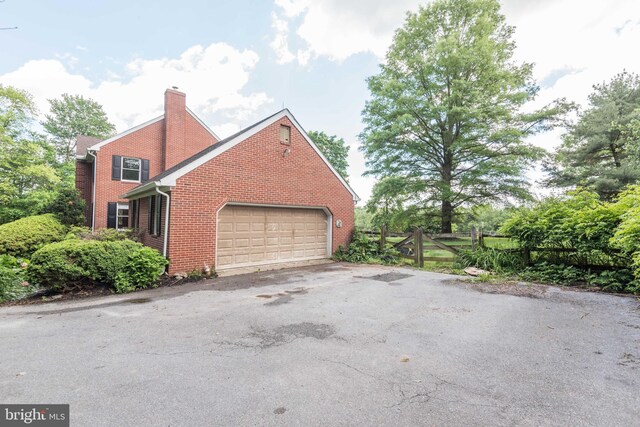 view of side of home with a garage