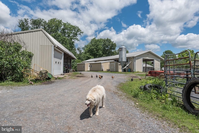 view of front of property featuring a garage and an outdoor structure