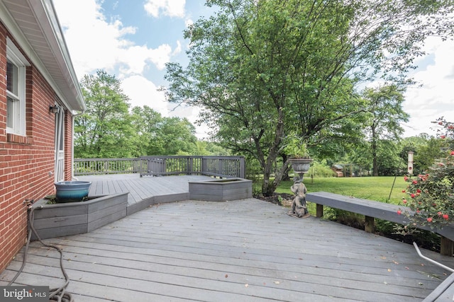 wooden terrace with a lawn