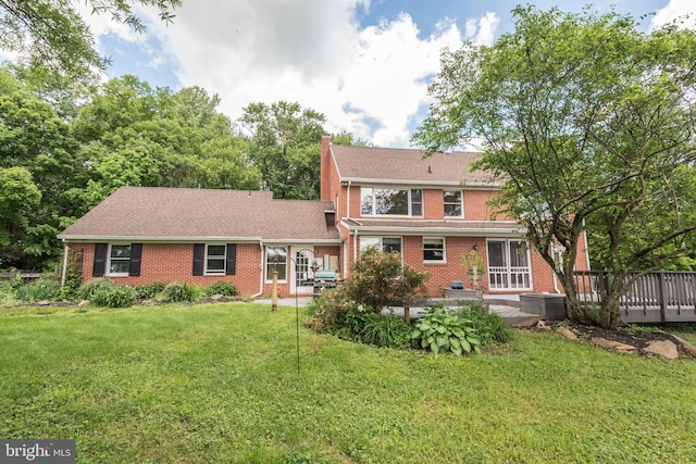 view of front of property with a front yard and central AC