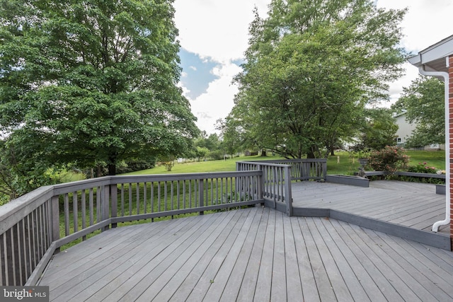 wooden terrace featuring a yard