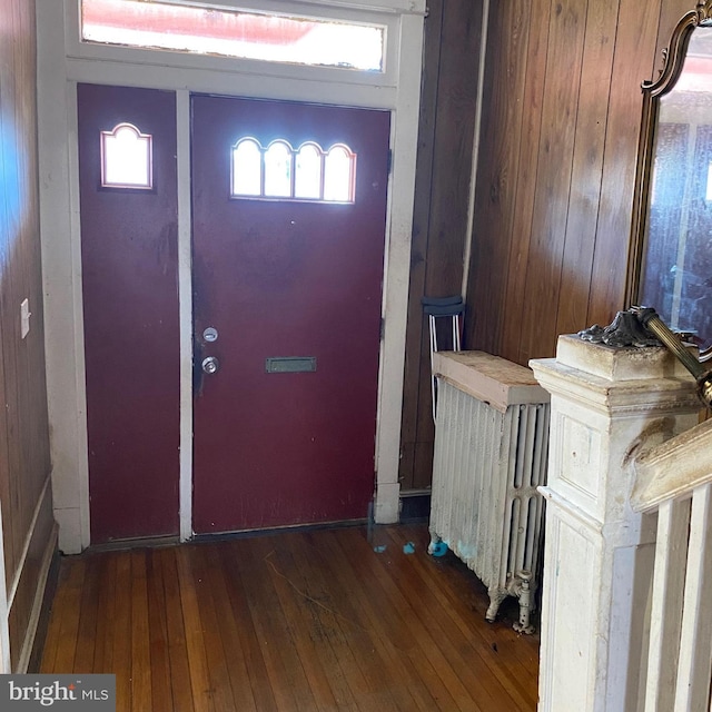 entrance foyer featuring radiator and dark wood-type flooring