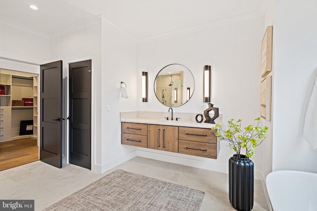 bathroom featuring vanity, wood-type flooring, and ornamental molding