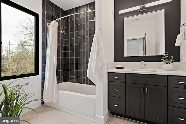 bathroom featuring vanity, tile patterned flooring, shower / bathtub combination with curtain, and a healthy amount of sunlight