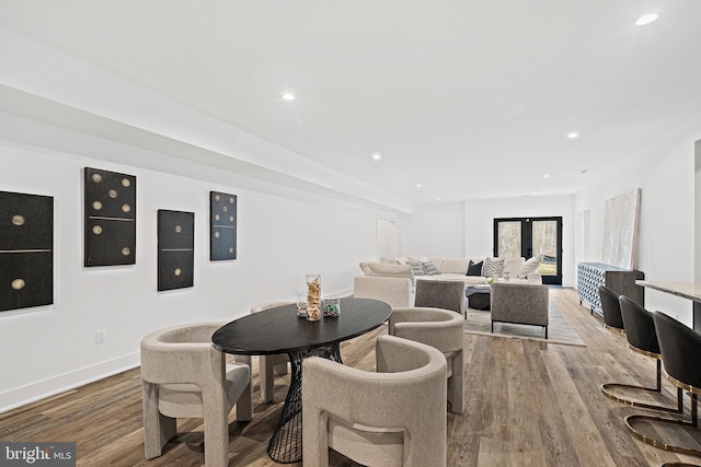 dining space with french doors and hardwood / wood-style flooring