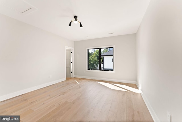 unfurnished room with light wood-type flooring