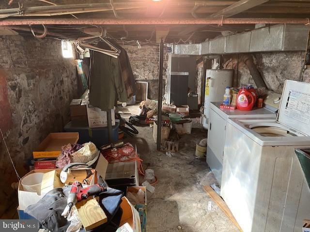 basement with water heater and washer and clothes dryer