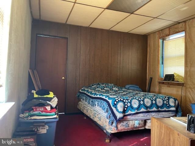 carpeted bedroom with a paneled ceiling