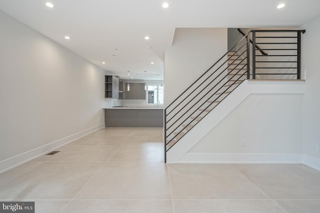 staircase featuring concrete floors