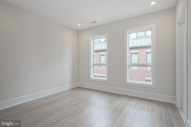 spare room featuring light hardwood / wood-style floors