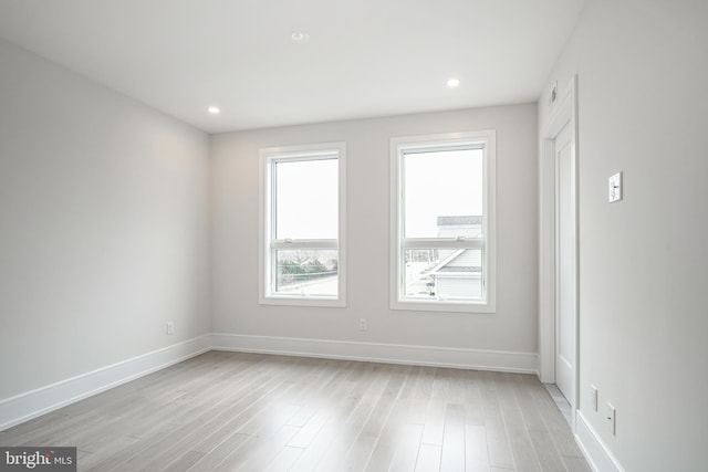 unfurnished room with light hardwood / wood-style flooring