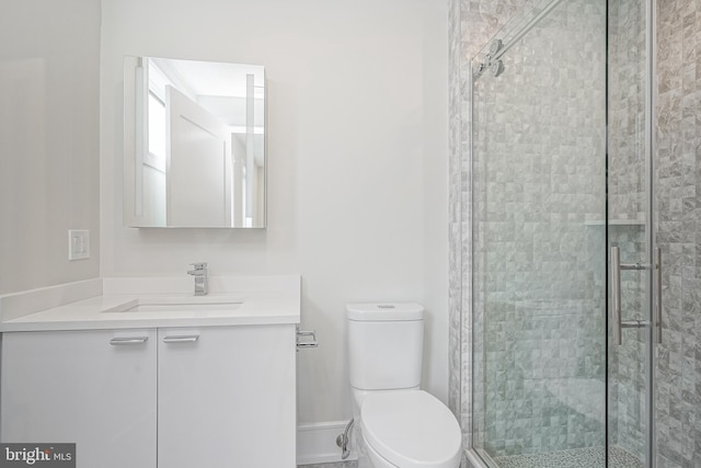 bathroom featuring vanity, toilet, and an enclosed shower