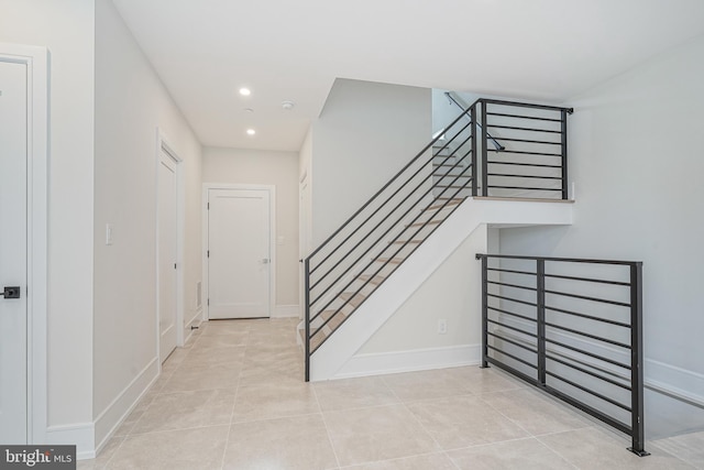 stairway featuring tile patterned flooring