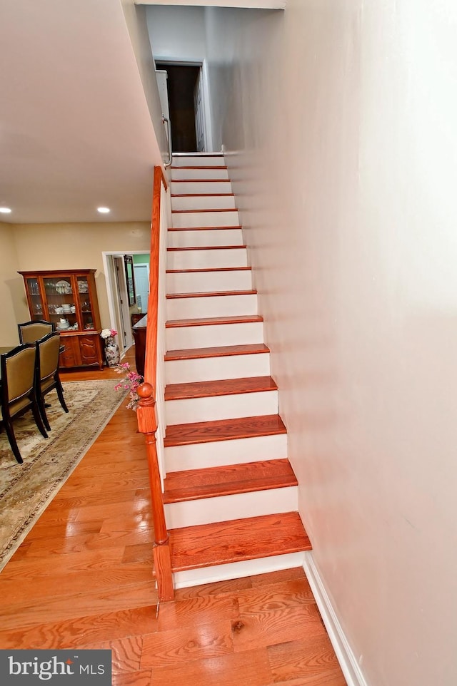 staircase with light hardwood / wood-style floors