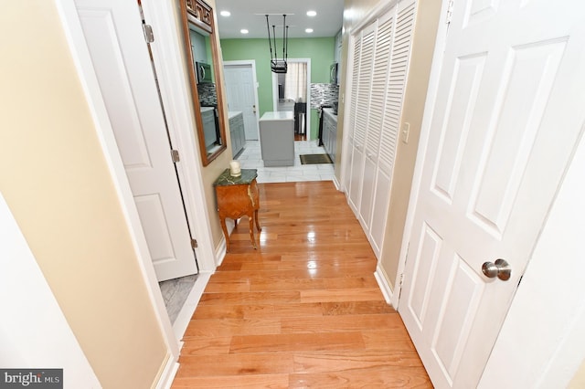 corridor with light hardwood / wood-style flooring