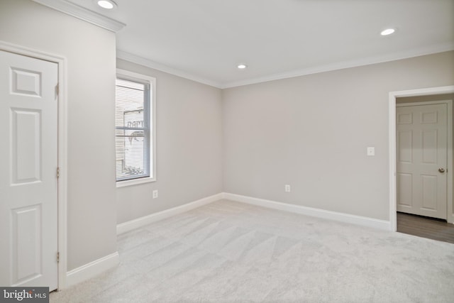 carpeted spare room with ornamental molding