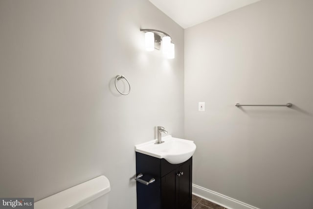 bathroom featuring toilet, tile patterned floors, and vanity