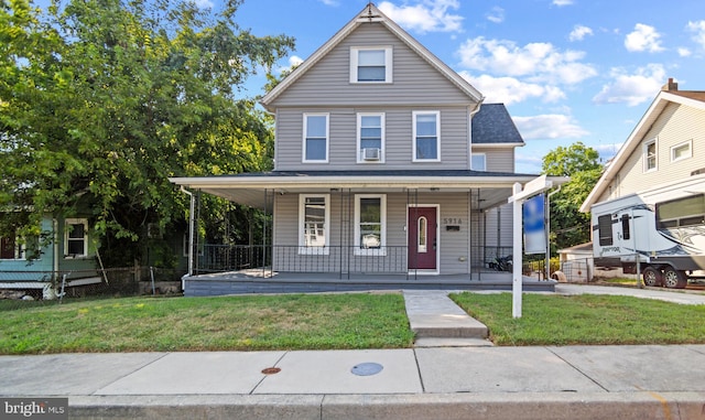 view of front of property with a front yard and a porch