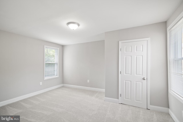 unfurnished bedroom featuring light colored carpet