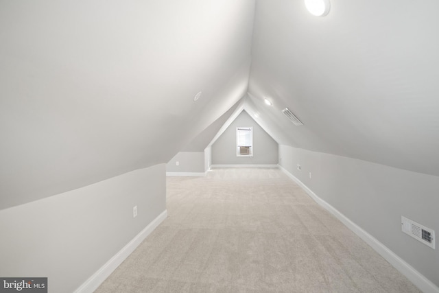 additional living space with light carpet and lofted ceiling