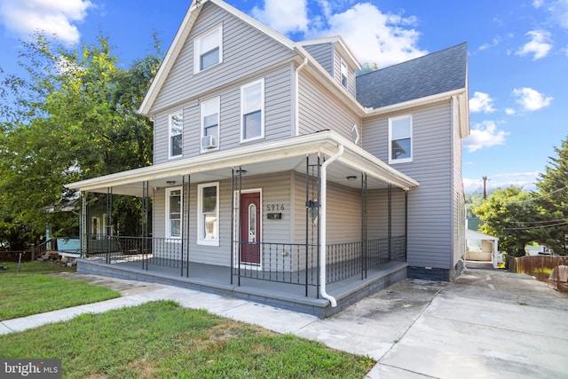 view of front of property with a front yard and covered porch