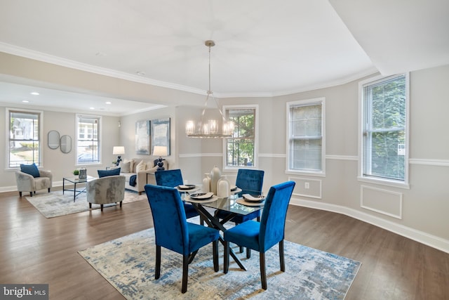 dining room featuring a chandelier, ornamental molding, and hardwood / wood-style floors