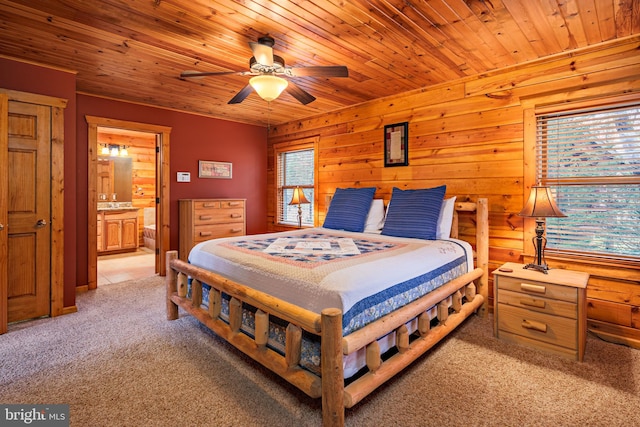 bedroom with ceiling fan, light colored carpet, ensuite bath, and wooden ceiling