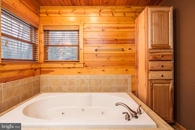 bathroom with wooden ceiling, a bathtub, and wooden walls