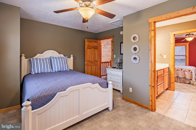 bedroom featuring light carpet, ceiling fan, and a textured ceiling