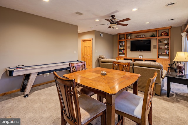 carpeted dining area featuring built in features and ceiling fan