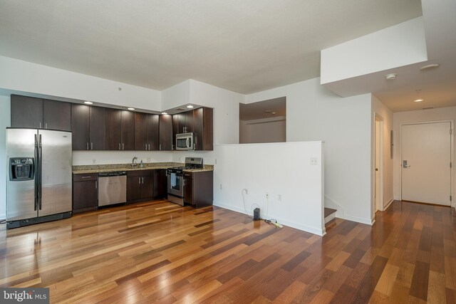 kitchen featuring dark brown cabinets, light hardwood / wood-style floors, sink, and stainless steel appliances