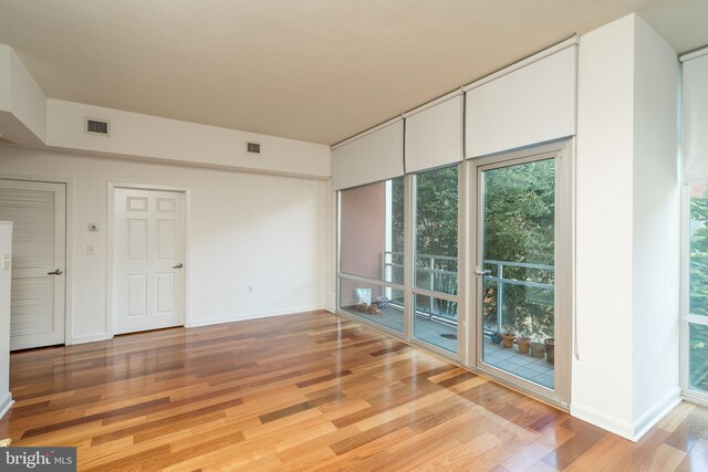 unfurnished room with light hardwood / wood-style floors