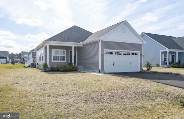 view of front of house featuring a porch, a front yard, a garage, and central air condition unit