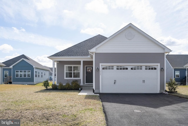 view of front of property with a front yard and a garage