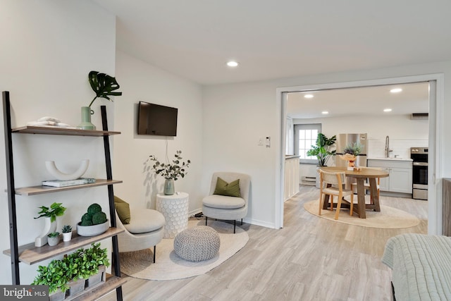 sitting room featuring light hardwood / wood-style flooring and sink