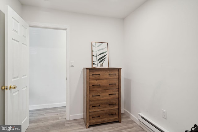 interior space with light wood-type flooring and baseboard heating