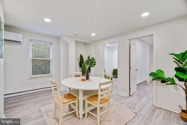 dining room with light wood-type flooring, a baseboard heating unit, and a wall unit AC